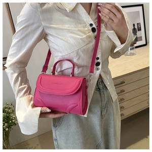 Detail of rose pink handbag with Fashion & Bag embossing and adjustable shoulder strap