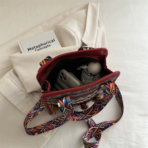 Ethnic bohemian woven crossbody bag with colorful tassels and geometric rainbow strap