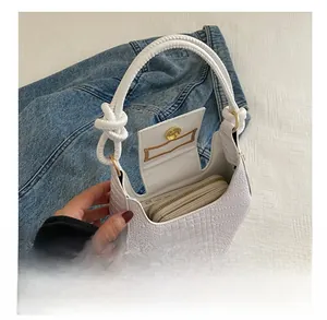 White crocodile-embossed baguette bag interior showing capacity for phone and wallet