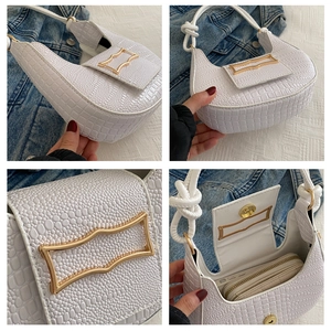 Detailed interior and exterior views of a white faux crocodile baguette hobo bag