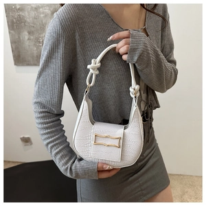 White faux crocodile skin hobo bag featuring a decorative gold buckle and knotted strap detail