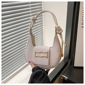 Close-up of white crocodile pattern hobo bag with gold metal buckle and knotted handle