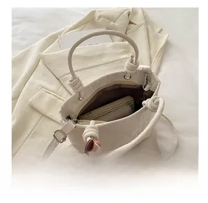 Detailed view showing inner storage capacity of cream white leather handbag