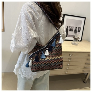 Detail van de bohemian crossbodytas met kleurrijke golfpatronen en blauwe franjes
