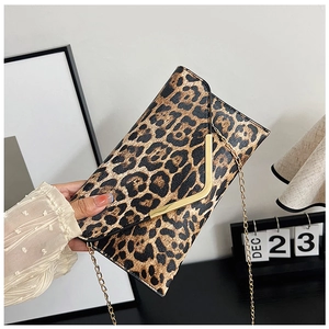 Close-up of leopard print envelope clutch bag with gold V-shape clasp and chain