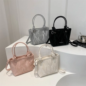 Chic ruched textured handbags in silver, black, pink, and beige with knot handles