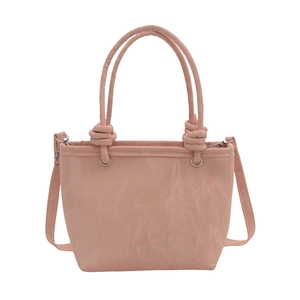 Pink minimalist leather bucket bag with top handles and adjustable crossbody strap