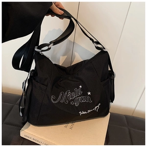 Detail of Michigan embroidered black canvas tote bag with side pocket in casual college style