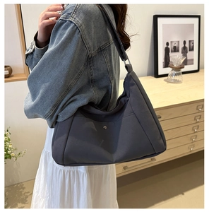Detail showing high-density dark grey canvas tote with magnetic metal buckle pocket