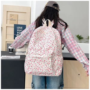 Floral canvas backpack for students featuring pink flower patterns and side pockets
