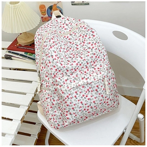 Floral nylon backpack with pink tulips on white fabric for women in a lifestyle setting