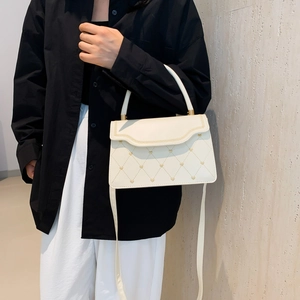 Elegant ivory quilted crossbody bag with golden heart studs and top handle for women
