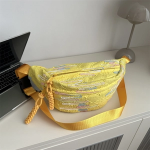 Yellow crossbody chest bag with colorful wave embroidery and woven zipper pulls