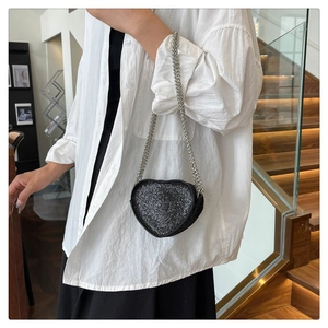 Fashionable heart-shaped crossbody bag with glittering rhinestones and silver chain strap