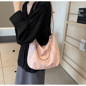 Detailed close-up of pink marble pattern tote bag with silver chain and strap
