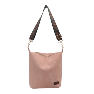Pink faux leather shoulder bag with vintage patterned wide strap on white background