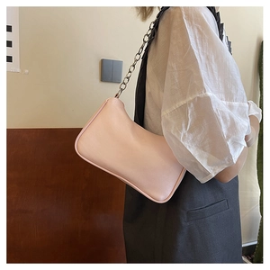 Pink faux leather hobo bag with a chunky silver metal chain strap worn by a model