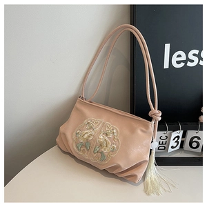 Detail of pink embroidered silk handbag with peony pattern and tassel ornament
