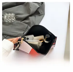 Interior view showing the large capacity of this colorful geometric pattern clutch bag
