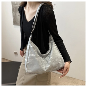 Detailed view of silver pleated hobo bag with unique crushed metallic texture and large capacity