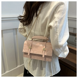 Detail of pink marble pattern crossbody bag with gold stud buckles and chain strap