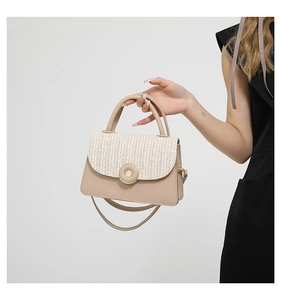 Detail of beige woven flap bag with leather trim and round clasp shown on model
