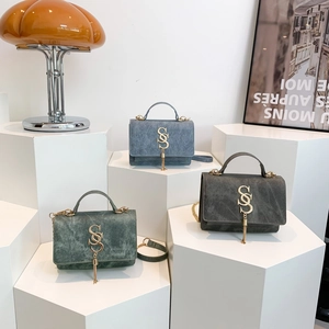 Chic crossbody bags in denim blue, green, and grey with gold S-logo and fringe details