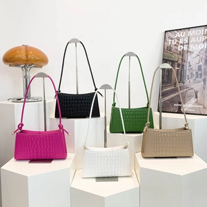 Chic crocodile pattern underarm bag in vibrant colors displayed on a stylish stage