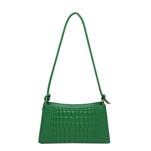 Green faux crocodile underarm bag with a knotted strap on a clean white background
