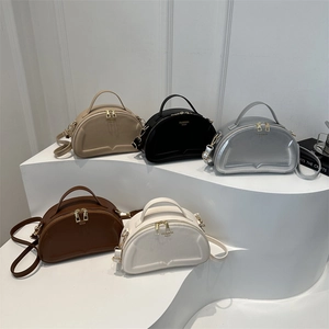 Minimalist semi-circular handbags in five colors with top handles and shoulder straps