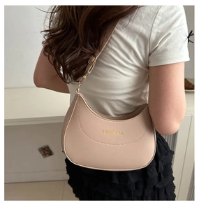 Close-up of beige crescent shoulder bag showing fine leather texture and golden FANTISSA logo