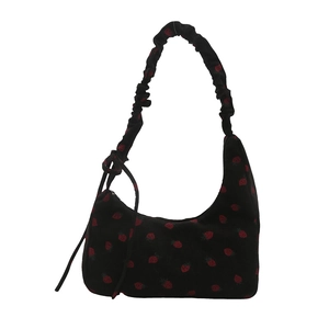 Corduroy shoulder bag with red strawberry print and ruched strap on white background