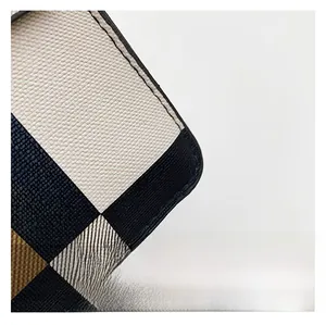 Detail shot of navy blue and white checkered crossgrain leather with neat stitching