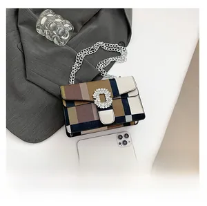 Detail showing colorful patchwork leather design with diamond buckle and silver chain strap
