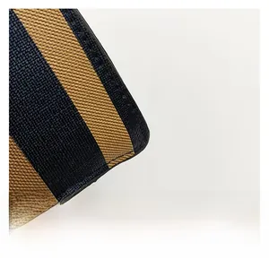 Detail of striped coated canvas material with crosshatch texture and premium stitching