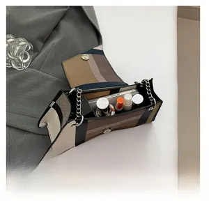 Detail view of the interior capacity showing daily essentials in a contrast chain bag