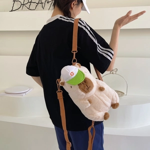 Cute capybara plush crossbody bag in beige with adjustable strap and stylish green baseball cap