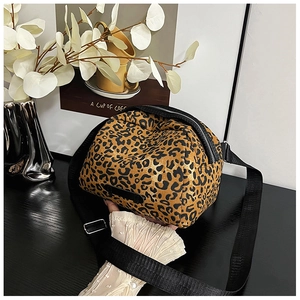 Detail of leopard print canvas bag with adjustable black nylon strap and zipper