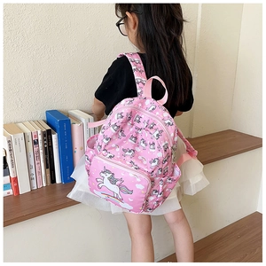 Detail of pink unicorn backpack showing side pockets and water-resistant fabric texture