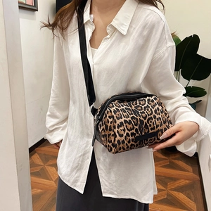 Fashionable leopard print shell crossbody bag with adjustable black shoulder strap