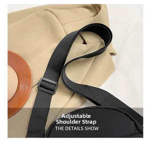 Detail shot of adjustable nylon shoulder strap with plastic buckle on minimalist chest bag