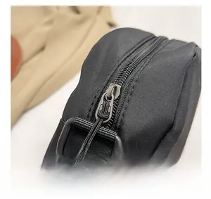 Close-up of durable black nylon fabric with smooth metal zipper and plastic D-ring detail