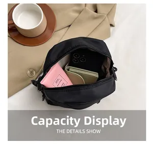 Interior view of minimalist black crossbody bag showing large storage capacity