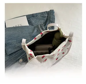 Interior view of white corduroy tote bag with strawberry embroidery and ample storage space