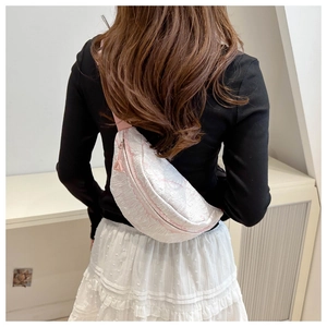 Detail of pink marble pattern waist bag with adjustable strap worn on the back