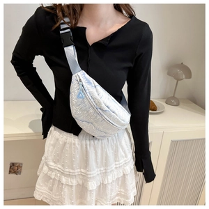 Detail of light blue jacquard chest bag with adjustable strap and geometric zipper