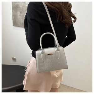 Silver crocodile texture handbag showing sleek shoulder strap and gold metal hardware