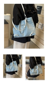 Detail of light blue tote bag featuring white bows and heart-shaped silver metallic accents
