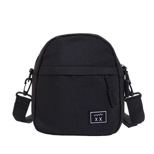 Minimalist black nylon crossbody chest bag with adjustable strap and front logo patch