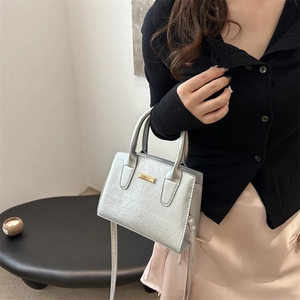 Silver crocodile embossed tote bag with gold metal trim and adjustable strap for women